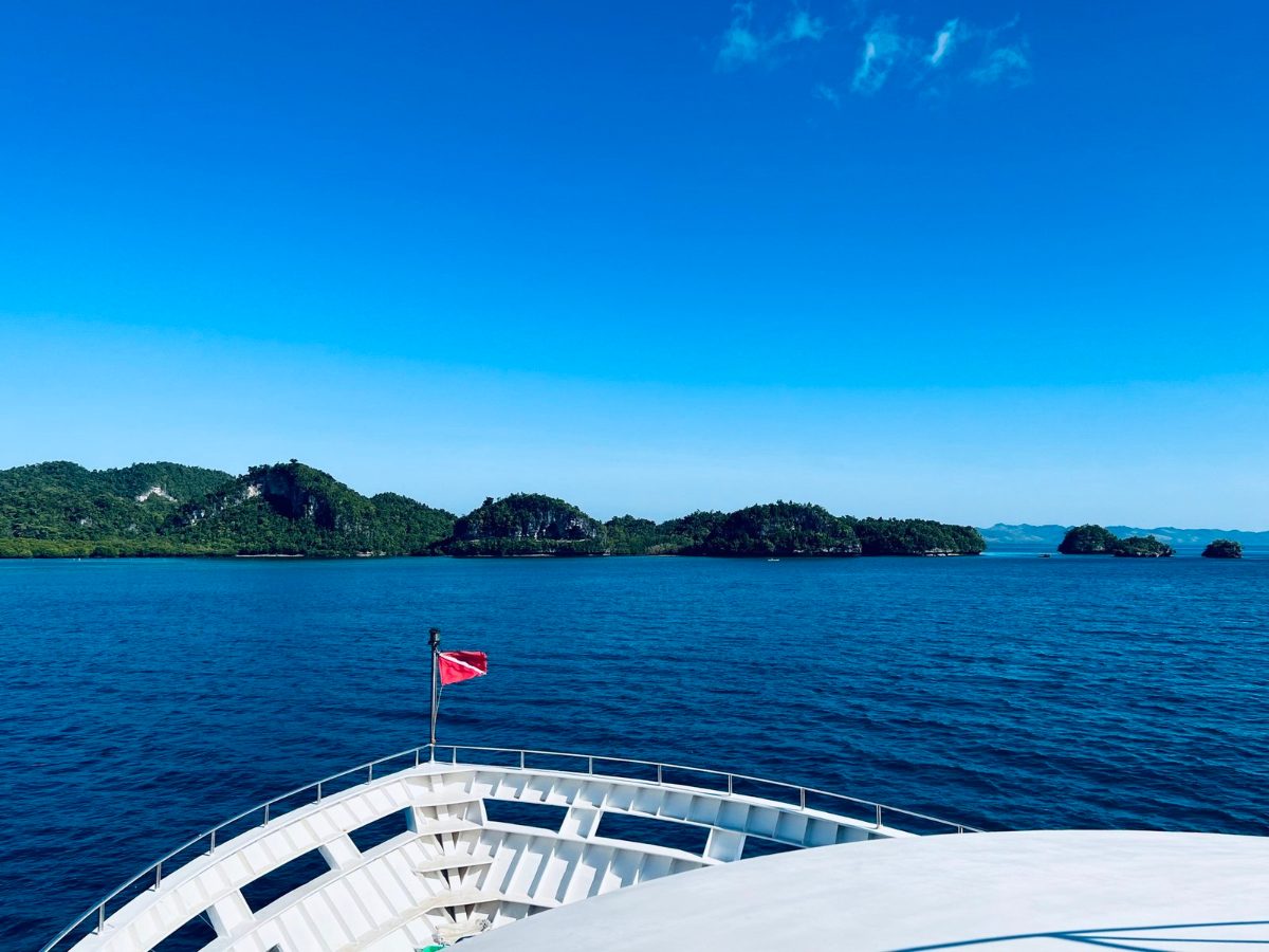 The bow of the dive boat heading toward an island