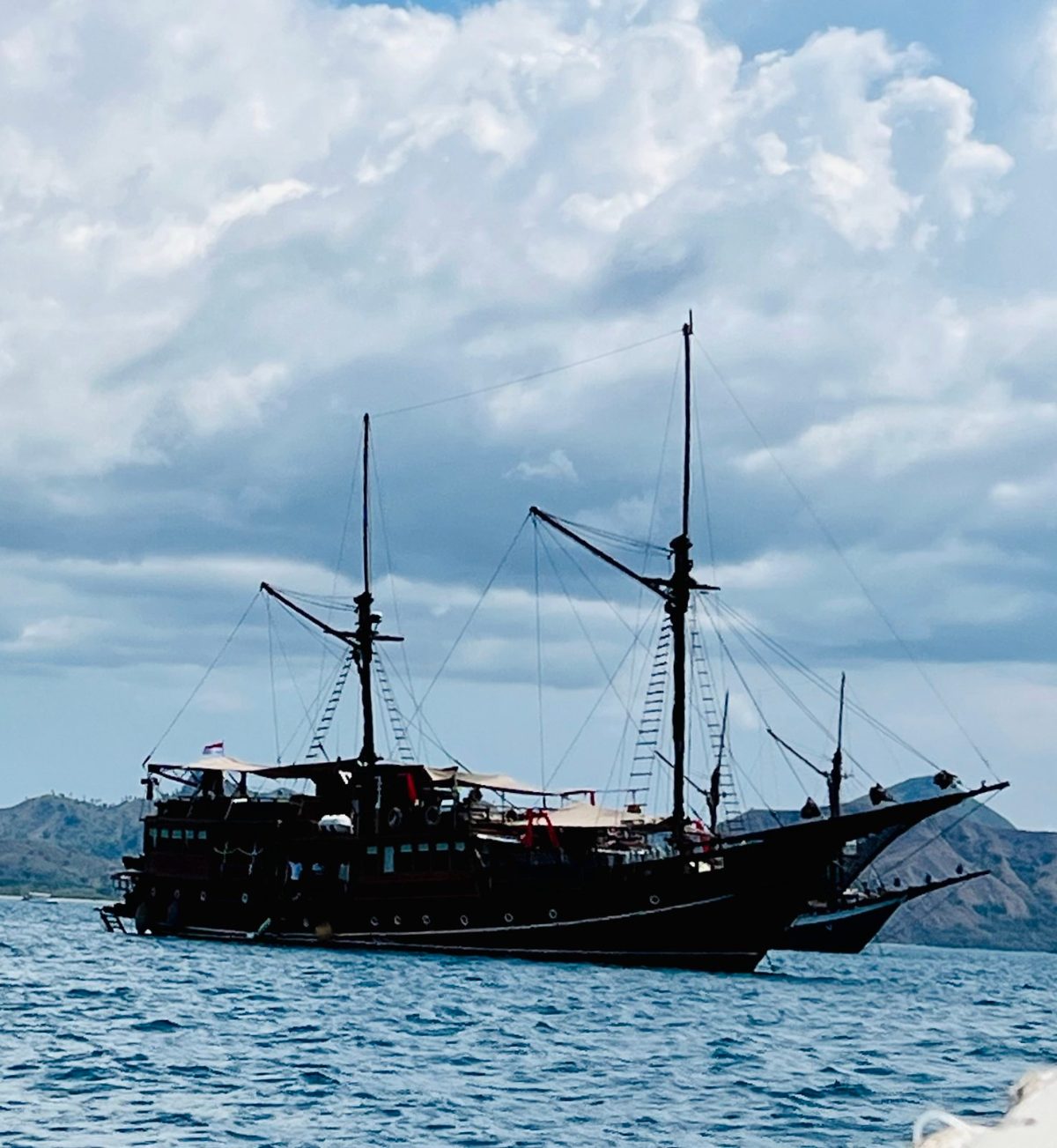 Traditional wooden phinisi anchored off Labuan Bajo, Flores