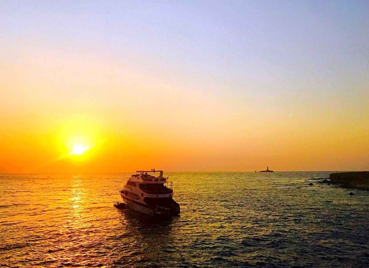 Another dive boat silhouetted against a Red Sea sunset