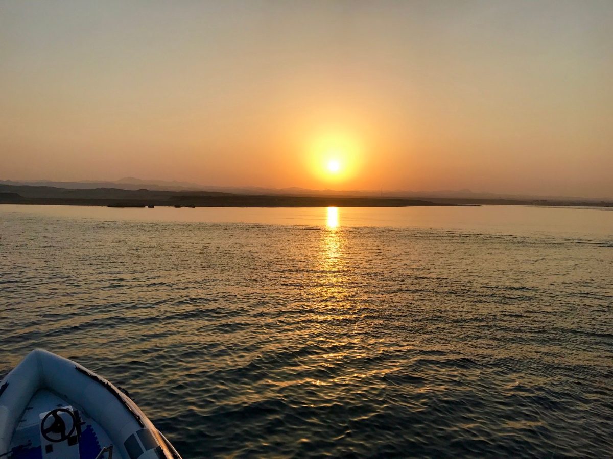 Sun setting over calm Red Sea water